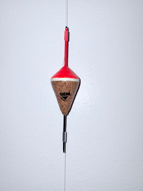 Orange unweighted fixed cork fishing float attached to a fishing line, on a white background.